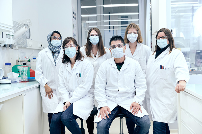 group of scientist in labs wearing masks