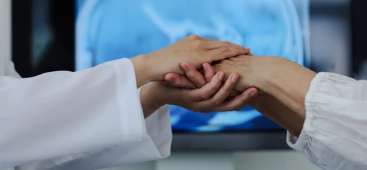 Doctor holding patients hand