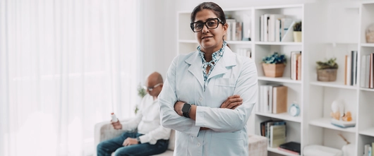 Doctor with patient in the background