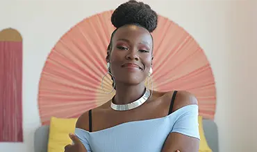 A portrait of a smiling black, female woman