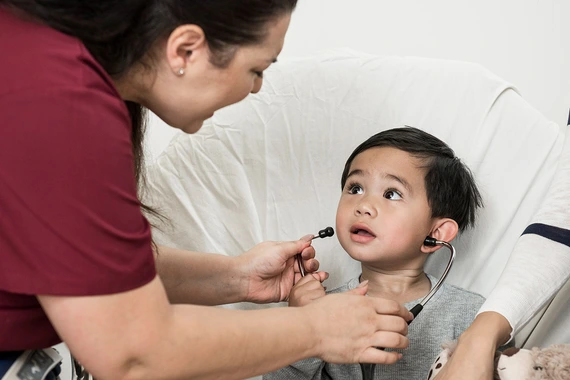 Young boy wearing stethoscope